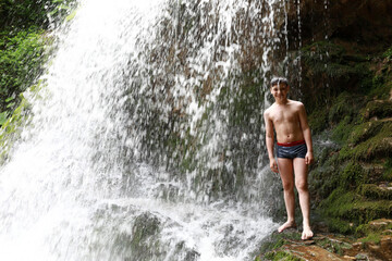 Kid under waterfall Shum on Rufabgo stream