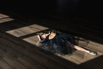 Ballerina laying down dance studio floor