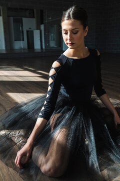 Young ballerina sitting on floor