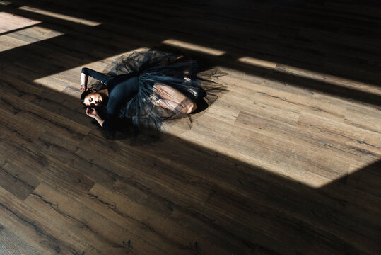 Ballerina laying down dance studio floor