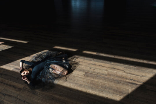 Ballerina laying down dance studio floor