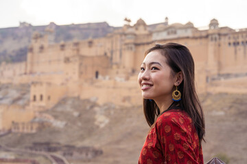 Asian woman admiring view of old fortress