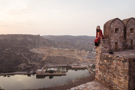 Ethnic Woman Sitting On Old Fort Wall