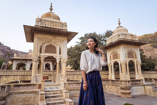 Glad Asian traveler in old ornamental building
