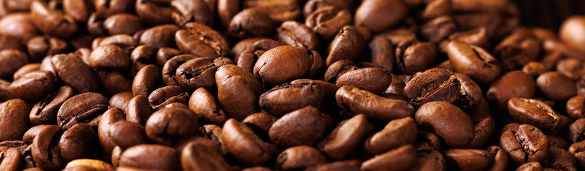 Close-up panoramic image of coffee beans. Selective focus.