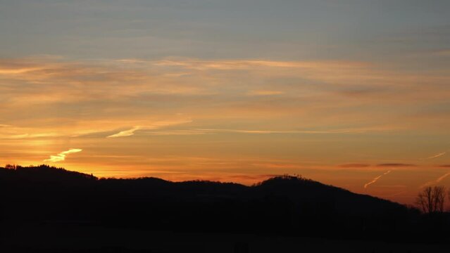 sunrise timelapse with mountains and red sky