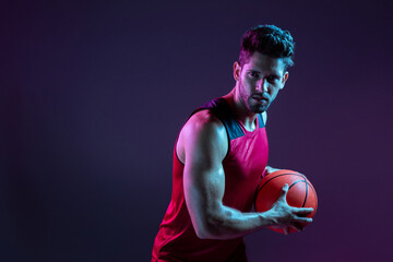 Studio Shot Of Basketball Player In The Studio with purple background