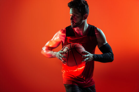 Studio Shot Of Basketball Player In The Studio with red background