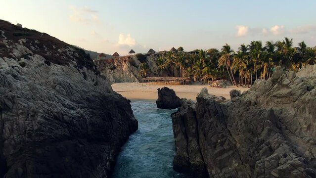 Idyllic Maruata Beach With Waves Splashing On Rock Formations In Michoacan, Mexico - drone shot