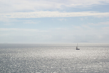 sailboat in the distance in the sea