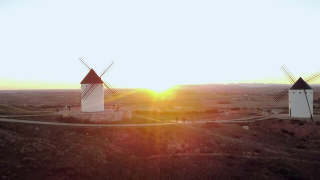 Relaxing aerial view of four windmills at sunset