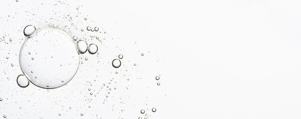 Fototapeta The texture of a cosmetic serum with bubbles in closeup. Copy space obraz