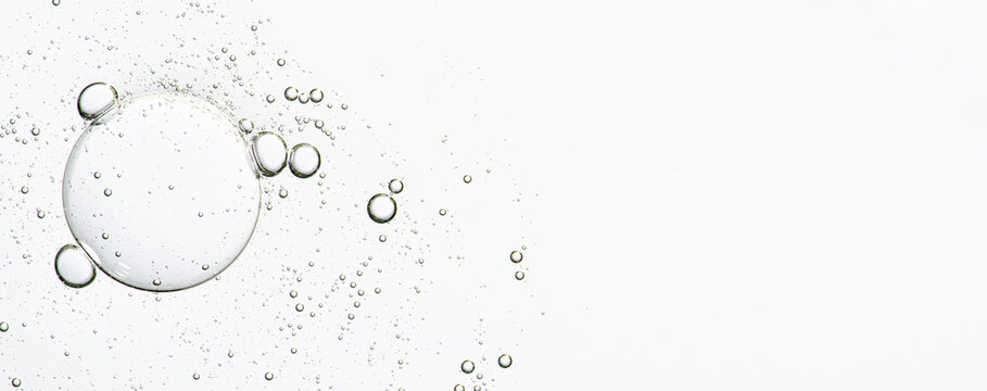 The texture of a cosmetic serum with bubbles in closeup. Copy space