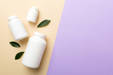 supplement pills with medicine bottle health care and medical top view. Vitamin tablets. Top view mockup bottle for pills and vitamins with green leaves, natural organic bio supplement, copy space