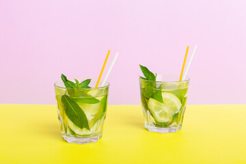 Mojito summer refreshing cocktail with ice and mint. mojito cocktail with lime, lemon and mint in a tall glass with a stick