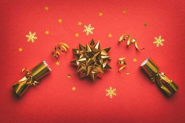 Christmas crackers with shiny confetti on color background, top view, copy space