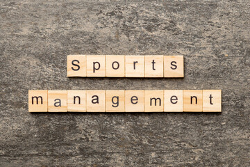 sports management word written on wood block. sports management text on cement table for your desing, concept