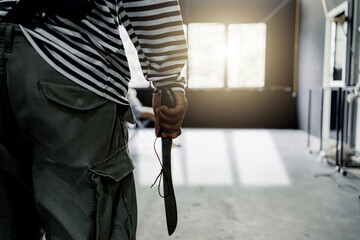 Hostage woman modle was captured by the villain. Criminal and villain concept.