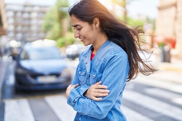 Young hispanic girl smiling confident standing at street