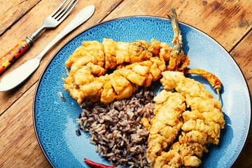 Deep fried sea bass with rice.