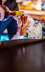 man bartender hand making negroni cocktail. Negroni classic cocktail and gin short drink with sweet...