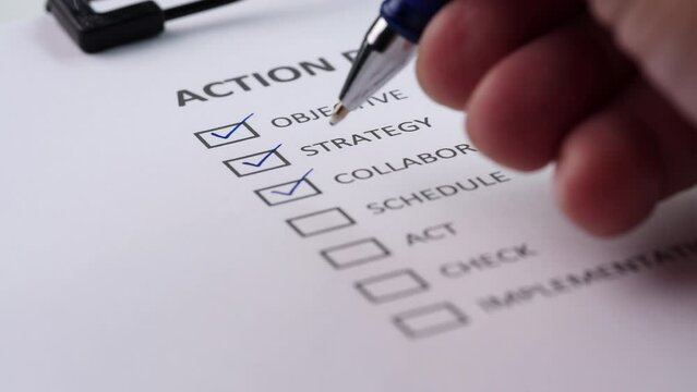 Concept of Action Plan, Checklist. Close-up businessman tick off or marking with red pen on action plan checklist, checkbox after completing task on white paper. Selective focus 4K resolution