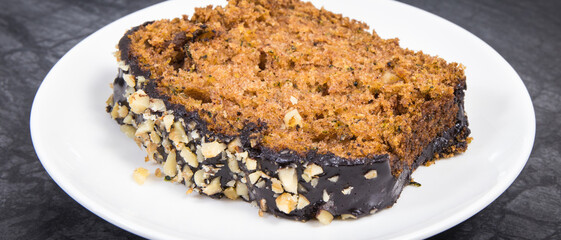 Homemade pastry made of zucchini with nuts and raisin on backgrond of concrete