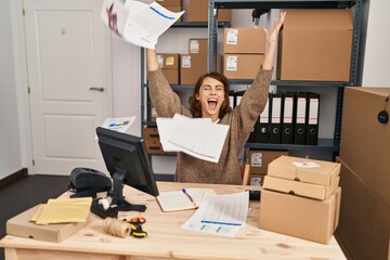 Young caucasian woman ecommerce business worker throwing documents at office