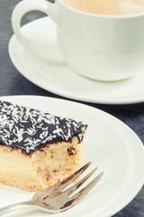 Fresh baked cheesecake and cup of white coffee. Delicious dessert