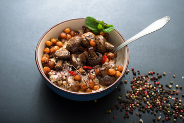 Healthy homemade food. Wild rice with mushrooms and caramelized chickpeas with cream sauce and spices on a dark background