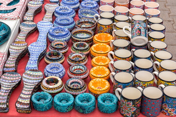 Ceramic kitchen utensils - cups, mugs, bowls, plates with traditional Turkish ornaments are sold at the street market