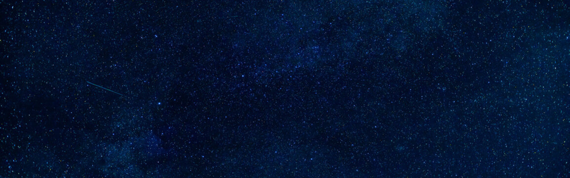 Starry Milky Way at night with stars on the background of a dark blue night sky