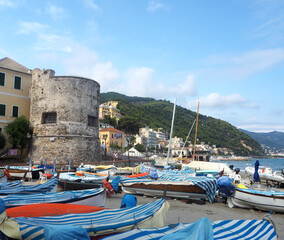 Fototapeta na wymiar Fishing boats in sunny day on the beach of Laigueglia, Savona, Liguria, Ligurian Sea, Italy.