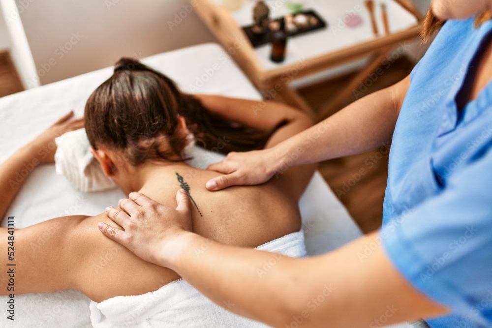 Canvas Prints Two women therapist and patient having massage session massaging back at beauty center