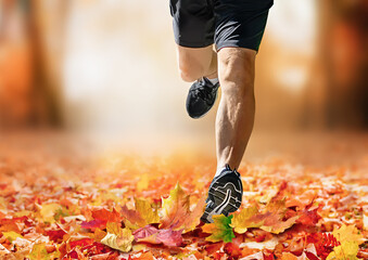 Man running in autumn park toward camera