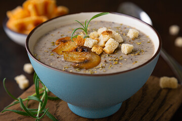 Hot mushroom cream soup with croutons