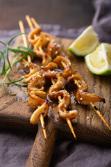 Squid skewers with soy sauce and sesame seeds
