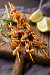 Squid skewers with soy sauce and sesame seeds