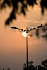 The morning sky with the silhouette of an electric post