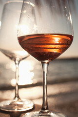 Two glasses of rose wine against the sunset sky.