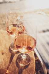 Two glasses of rose wine against the sunset sky.