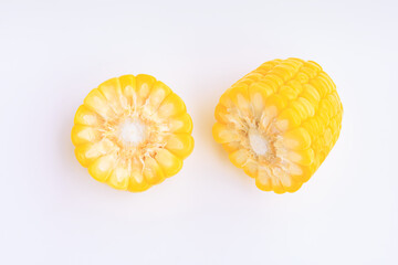 Yellow corn cobs slice on pink background, Top view
