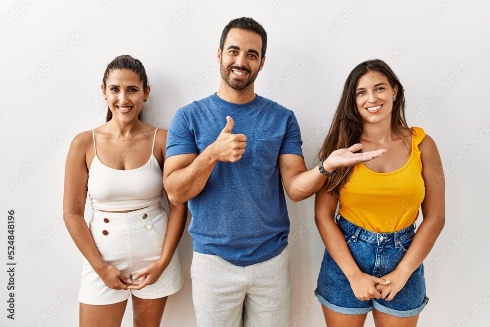 Sticker Group of young hispanic people standing over isolated background showing palm hand and doing ok gesture with thumbs up, smiling happy and cheerful