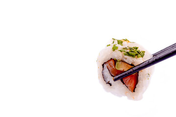 Close up of delicious japanese food with sushi roll  with salmon, tuna,  shrimp with wooden chopsticks  on white background Space for text