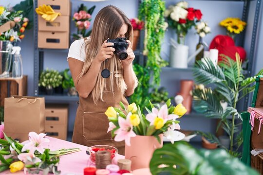 Young beautiful hispanic woman florist make photo to bouquet of flowes gift at flower shop