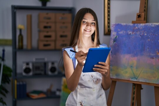 Adorable girl artist using touchpad drawing at art studio