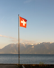Swiss flag with Alp Mountains on the back