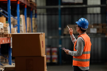 Warehouse workers selling stock checks with tablets .