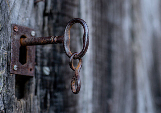 Rusty metal lock on wooden door