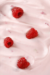 Texture, background of Pink Yogurt with  raspberries. Curl of Yogurt. Pink nature yogurt, sour cream, ice cream.